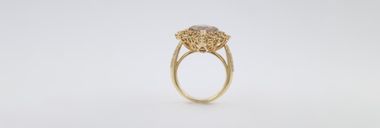 Yellow gold ring with a brown stone and diamonds